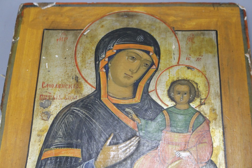 A 19th century Russian tempera on wood icon, 31 x 26cm and another smaller icon, 17.5 x 13cm